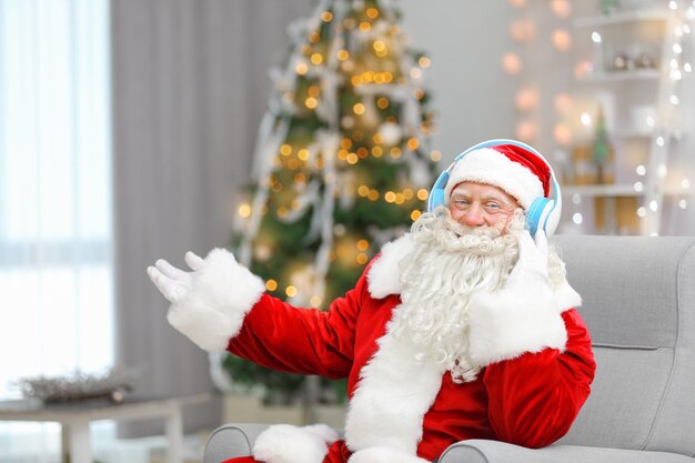 Santa Claus listening to music in living room