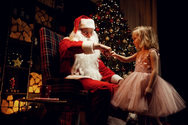 Santa Claus and little girl on christmas day