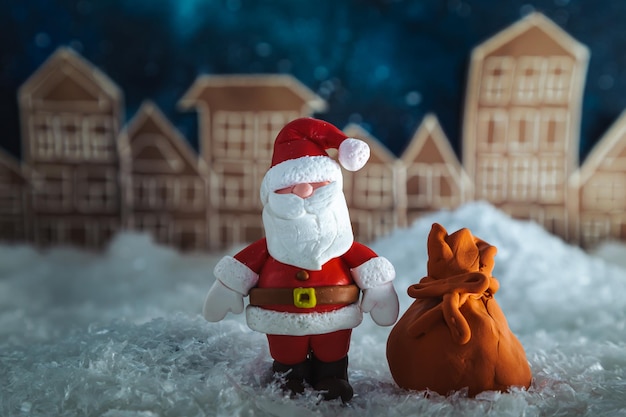 Santa Claus at night in a toy snowy town