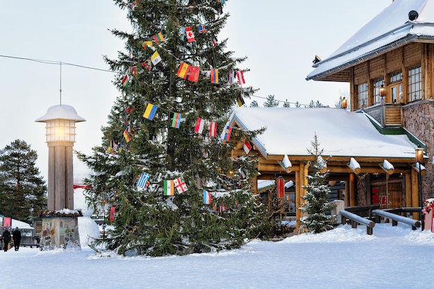 겨울에 북극권에 있는 핀란드 라플란드의 크리스마스 트리가 있는 산타 마을의 산타클로스 사무실. 배경에 사람들