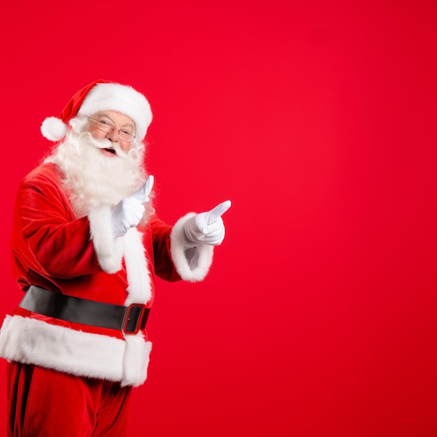 Photo santa claus pointing at something with his right hand generative ai