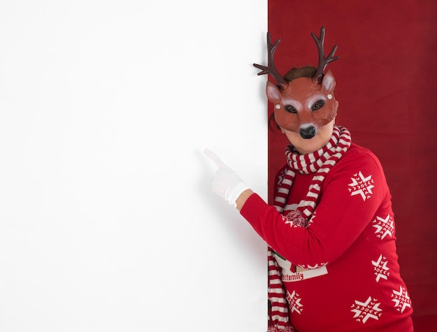 Santa Claus points to a white billboard