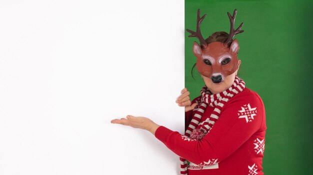 Santa Claus points to a white billboard