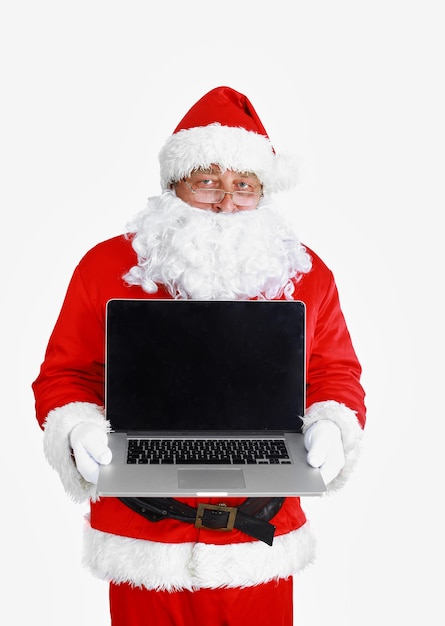 Santa Claus presents a laptop on white background.