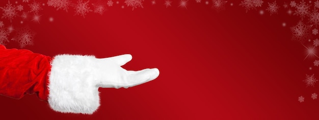 Photo santa claus presents something with his open hand