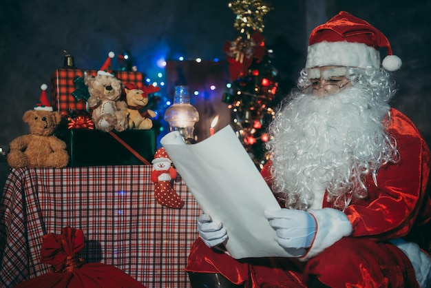 Santa claus read a paper at night in the houseThe light from the bookUsing the light from the lanter