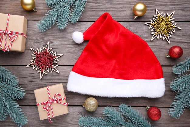 Santa Claus red hat and gifts on grey background. Christmas decoration.