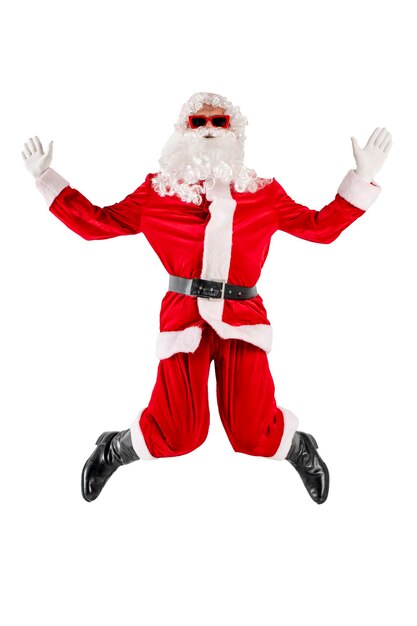 Santa claus in red suit with beard in glasses jumps up rejoices and welcomes on white background