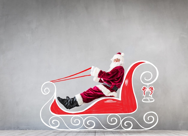 Photo santa claus riding sled. christmas xmas holiday concept