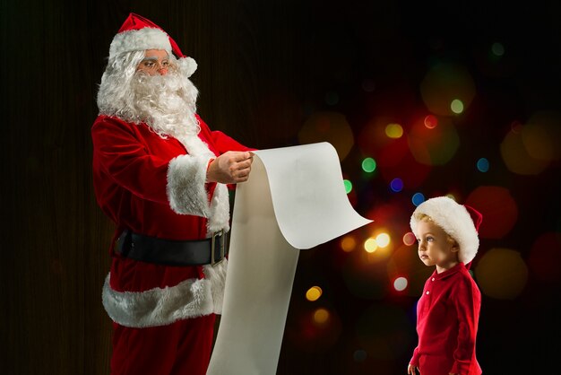 Santa claus searches from a list a gift for a child