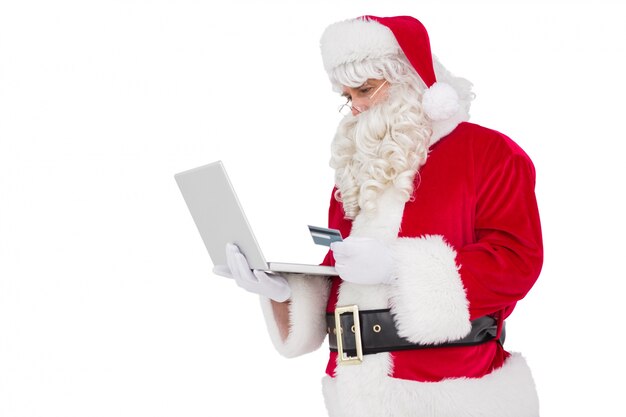 Santa claus shopping online with laptop 