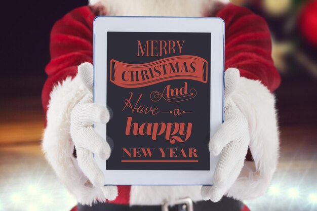 Santa claus showing digital tablet with christmas greeting