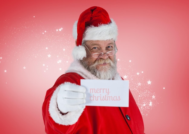 Santa claus showing a merry christmas card