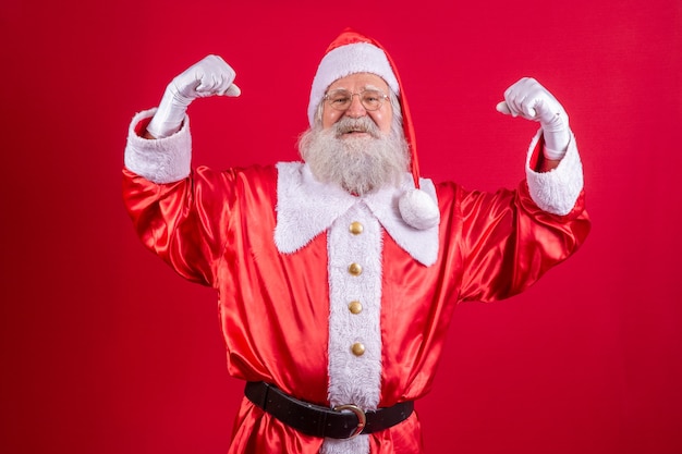 Santa Claus showing muscles. strong Santa Claus