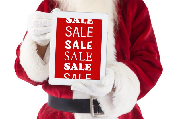 Photo santa claus showing tablet pc against sale advertisement