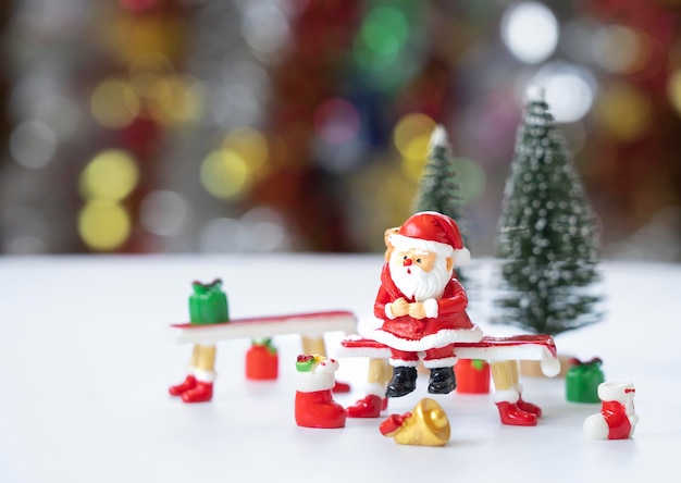 Santa Claus sitting on a red pew with gifts in anticipation of the funny and happiness festival.