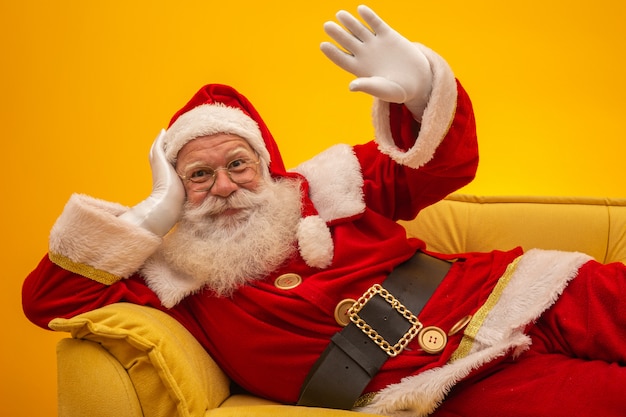 Santa claus sitting on a yellow couch