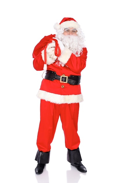 Photo santa claus standing with his sack full of presents isolated on white background full length portrait