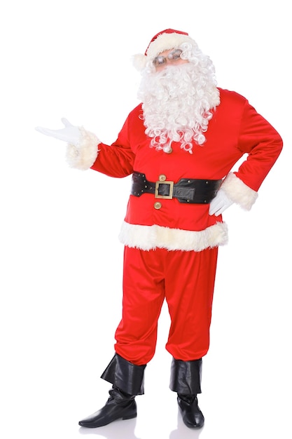 Santa Claus standing with a welcome gesture isolated on white background Full length portrait