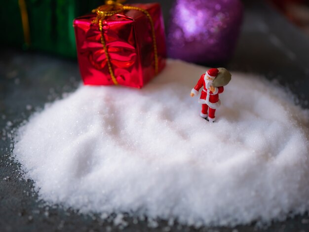 Santa Claus through the snow to give away gifts to children