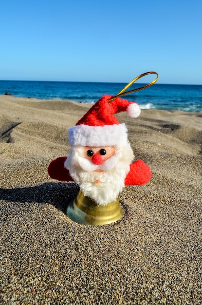 Santa Claus Toy on the Sand Beach