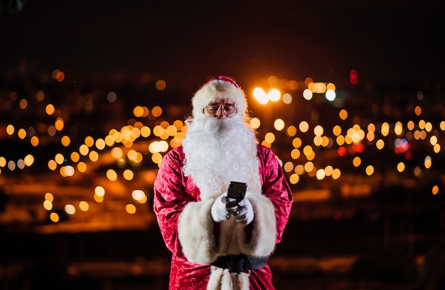 Santa Claus using mobile phone at night