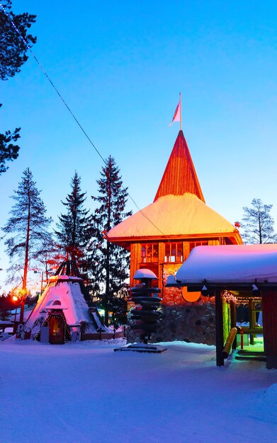 Santa Claus village at Rovaniemi of Finland Lapland. Christmas office house winter. Laponia and snow. Travel to Joulupukki at Holiday park on north pole. New year.  Post with lights. Tree decoration