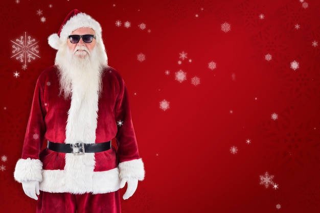 Santa claus wears black sunglasses against red snowflake background