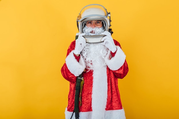 Santa Claus with astronaut helmet on yellow