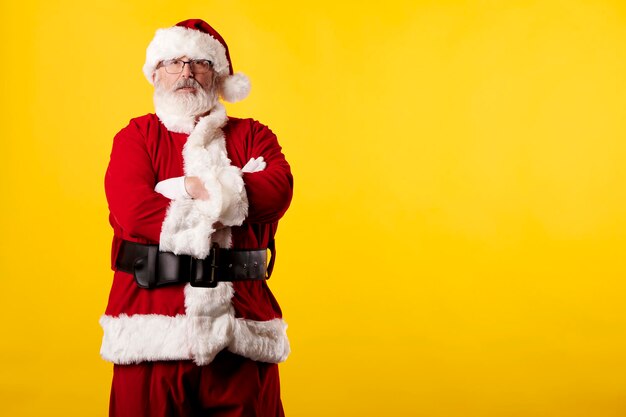 Santa claus with crossed arms on a yellow background