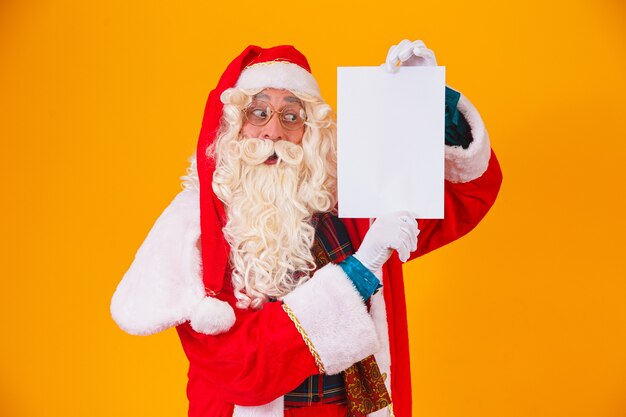 Santa Claus with a white banner with space for text. Santa Claus holding a white card