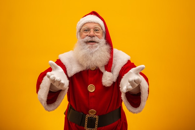 Santa Claus on yellow background with copy space.