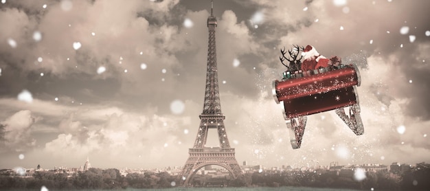 Santa flying his sleigh against paris under cloudy sky