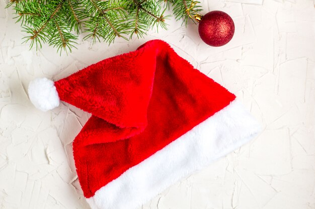 Santa hat and fir tree branches. Christmas composition. Top view, flat lay