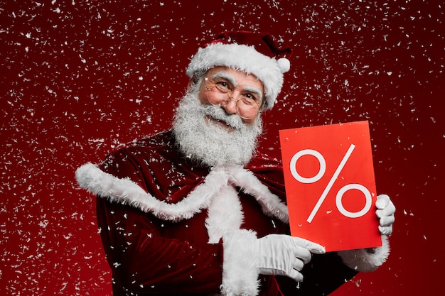 Santa Holding Sale Sign in Sneeuw