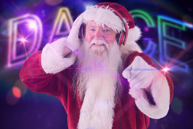 Santa is listening some music against digitally generated colourful dance text