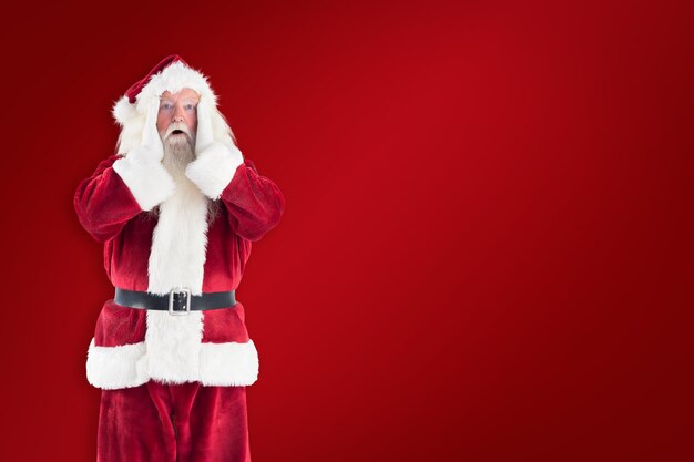 Santa is shocked to camera against red background