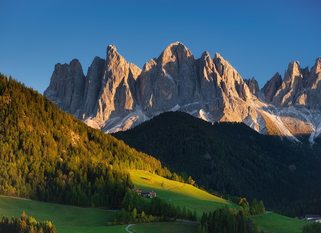 Santa Maddalena Val di Funes Dolomite Alps Italy The mountains and the forest before sunset Natural landscape in the summertime Photo in high resolution