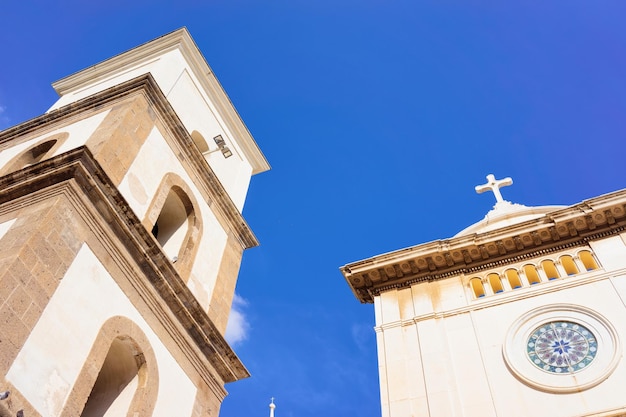 Santa Maria Assunta Church in Positano town on Amalfi Coast and Tyrrhenian Sea in Italy in summer. View of beautiful Mediterranean cathedral architecture near Sorrento. Blue sky on background