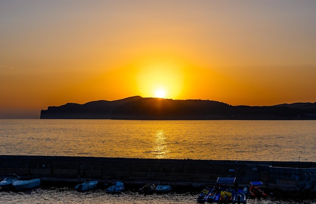 Santa Ponsa Mallorca Spain Sunset with orange sun mountain sea