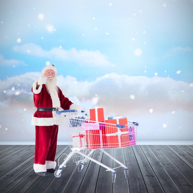 Photo santa pushing a shopping cart against clouds in a room