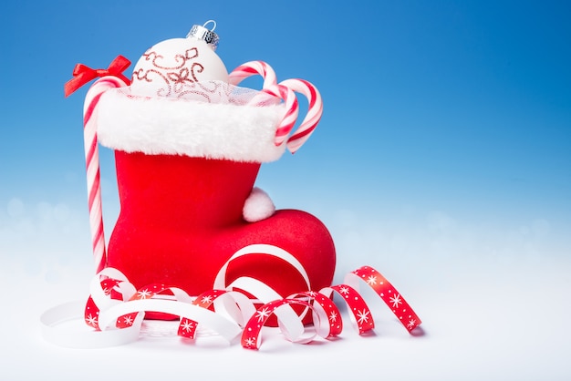 Santa's boot with candy canes, text 