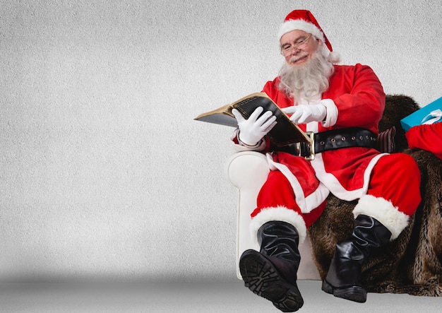 Santa sitting on sofa and reading book