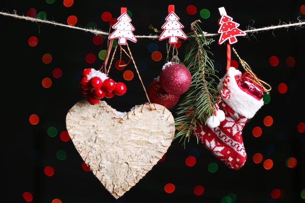 Santa sock and Christmas accessories on black background with lights