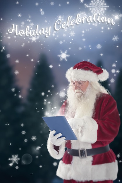 Santa uses a tablet PC against fir tree forest