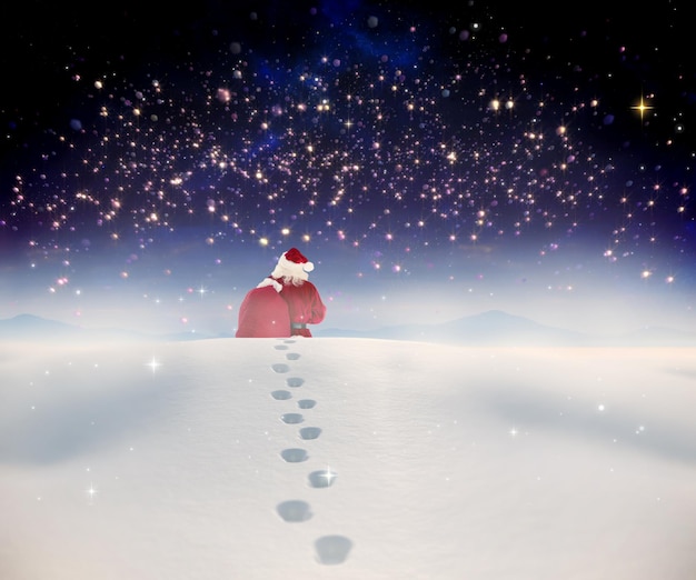 사진 고요한 풍경을 배경으로 눈 속을 걷는 산타