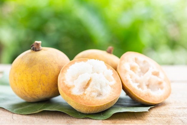 Santol tropical fruit on wooden table