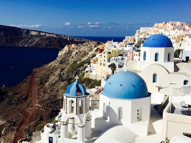 santorini against blue sky on sunny day