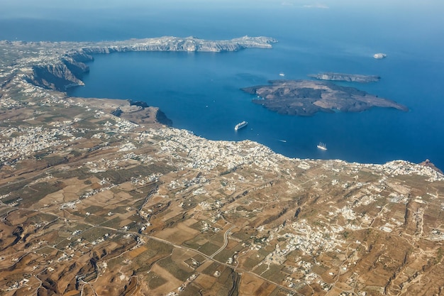 Santorini island holidays in greece travel traveling fira thera\
town mediterranean sea aerial photo view santorin