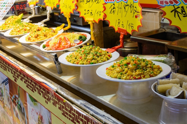 Sanya, Hainan/China - January 7, 2020: Chinese street food. Street trading. Chinese kinds of fresh seafood at an asian seafood market in Sanya, Hainan province, China. Inscription: name food.